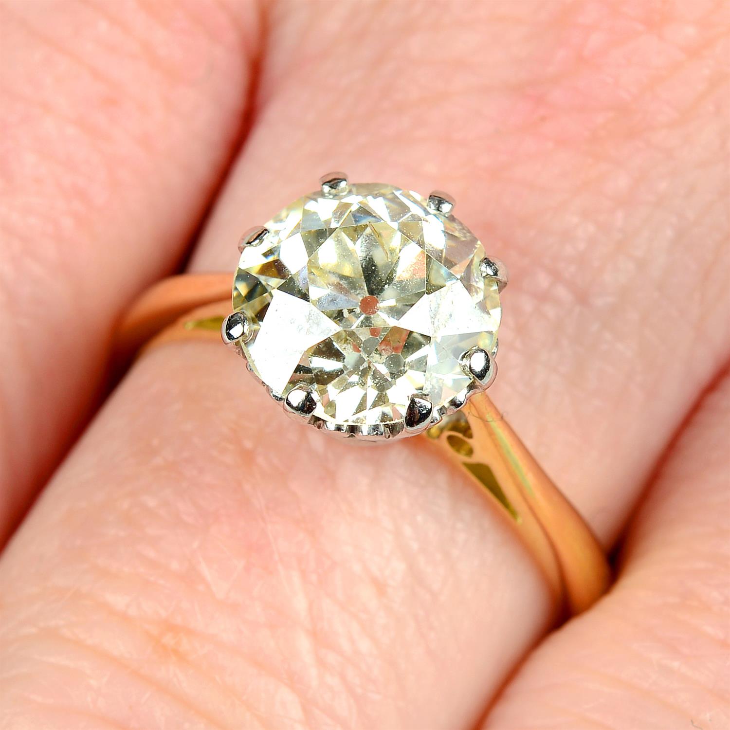 An 18ct gold circular-cut diamond single-stone ring.