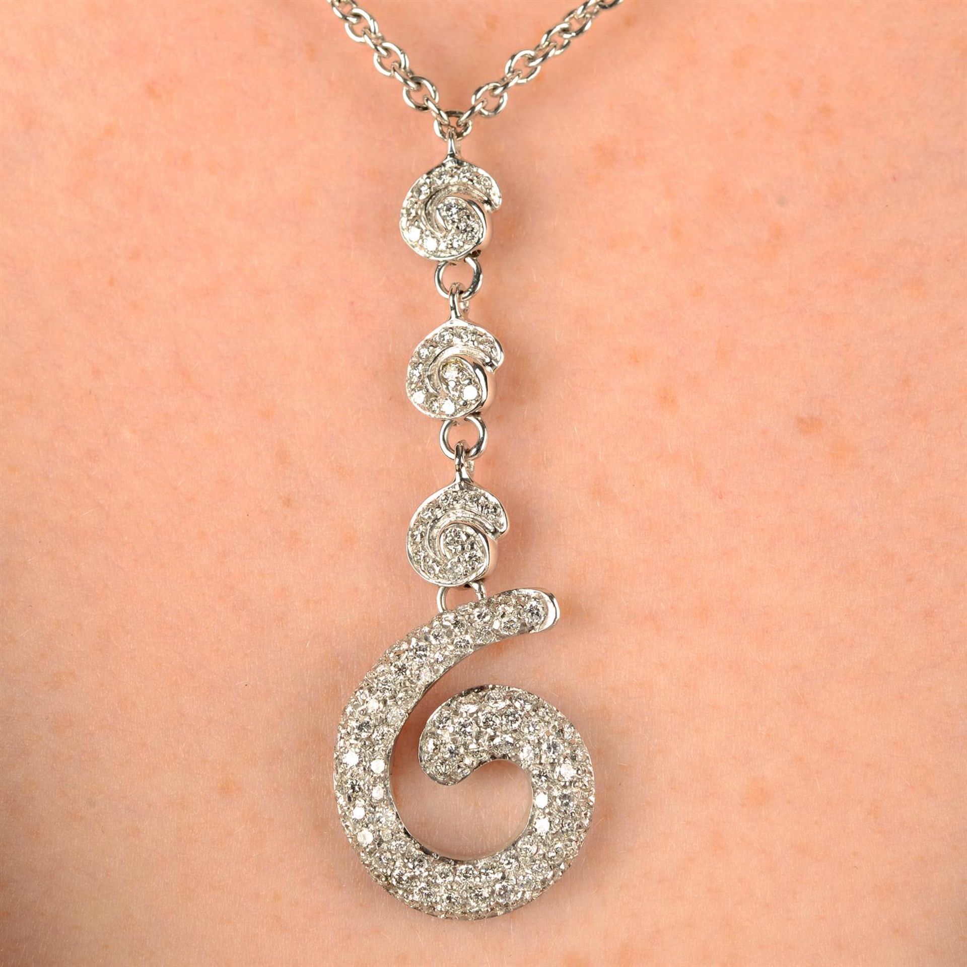 A pavé-set diamond scroll pendant necklace.