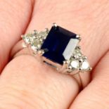 A sapphire ring, with brilliant-cut diamond trefoil shoulders.