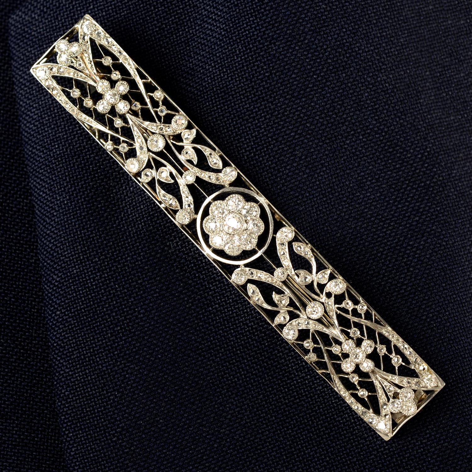 A Belle Epoque platinum old and rose-cut diamond stylised floral bar brooch.