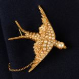 A late Victorian gold split pearl swallow brooch, with ruby eyes.
