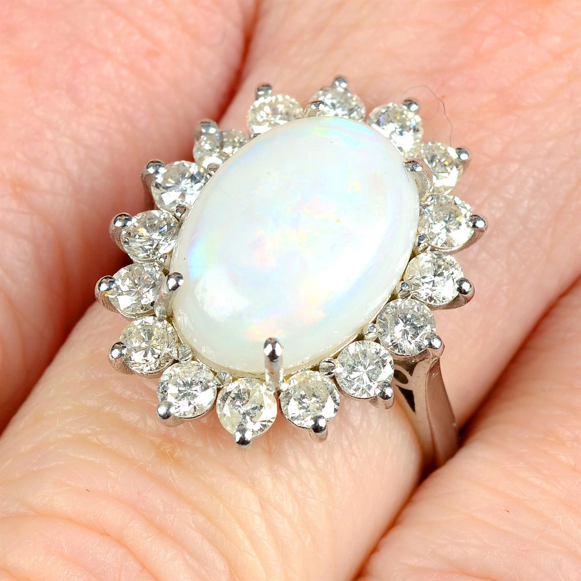 An opal and brilliant-cut diamond cluster ring.