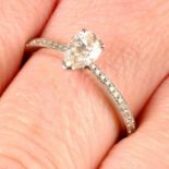 An 18ct gold pear-shape diamond single-stone ring, with brilliant-cut diamond shoulders.