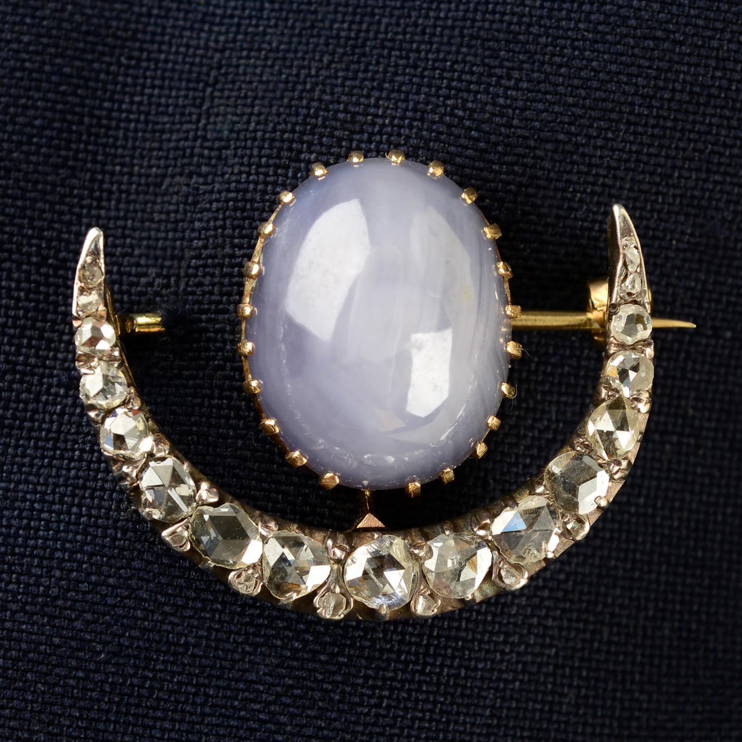 A late 19th century silver and gold rose-cut diamond crescent brooch, with star sapphire cabochon