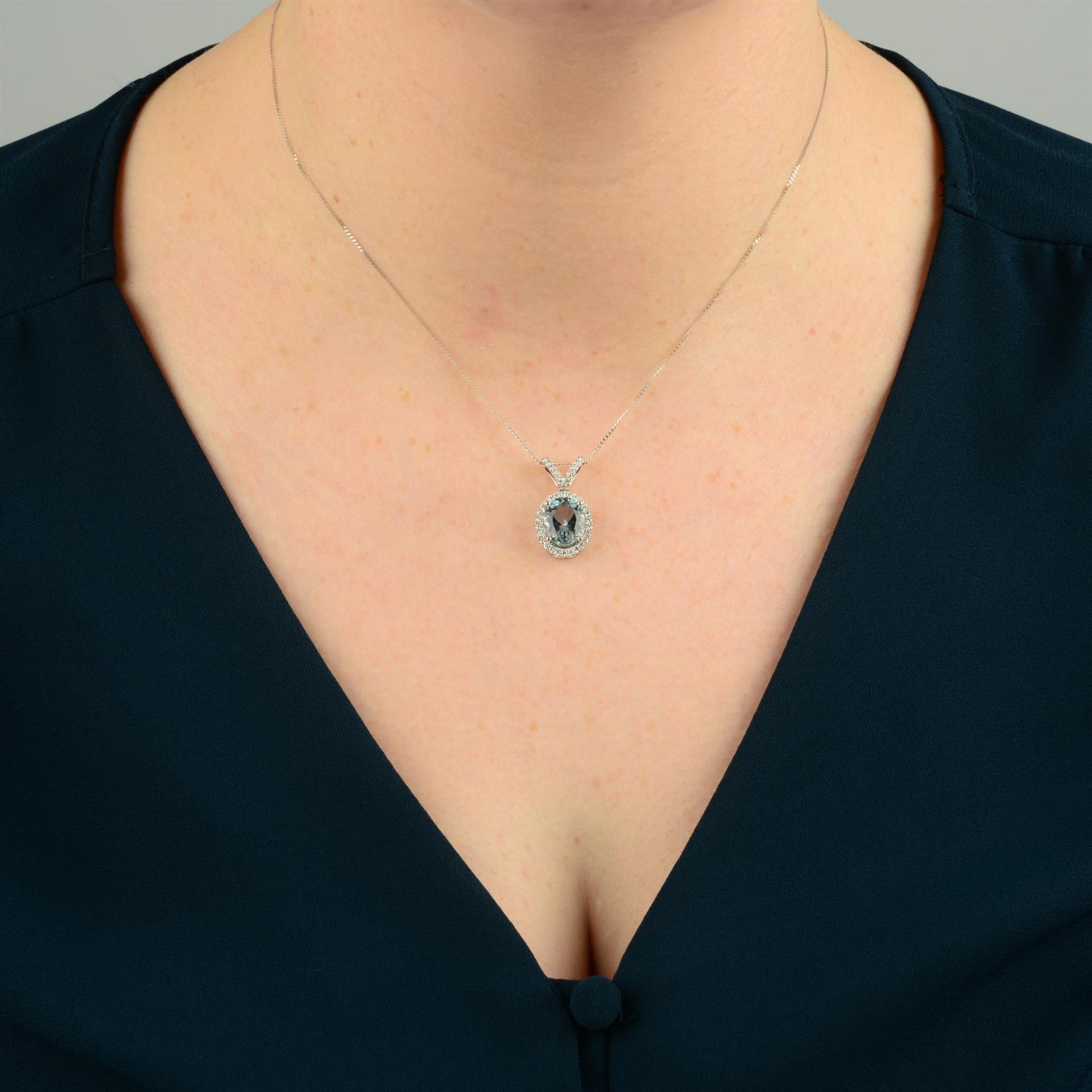 An 18ct gold aquamarine and brilliant-cut diamond pendant, with trace-link chain. - Image 5 of 5