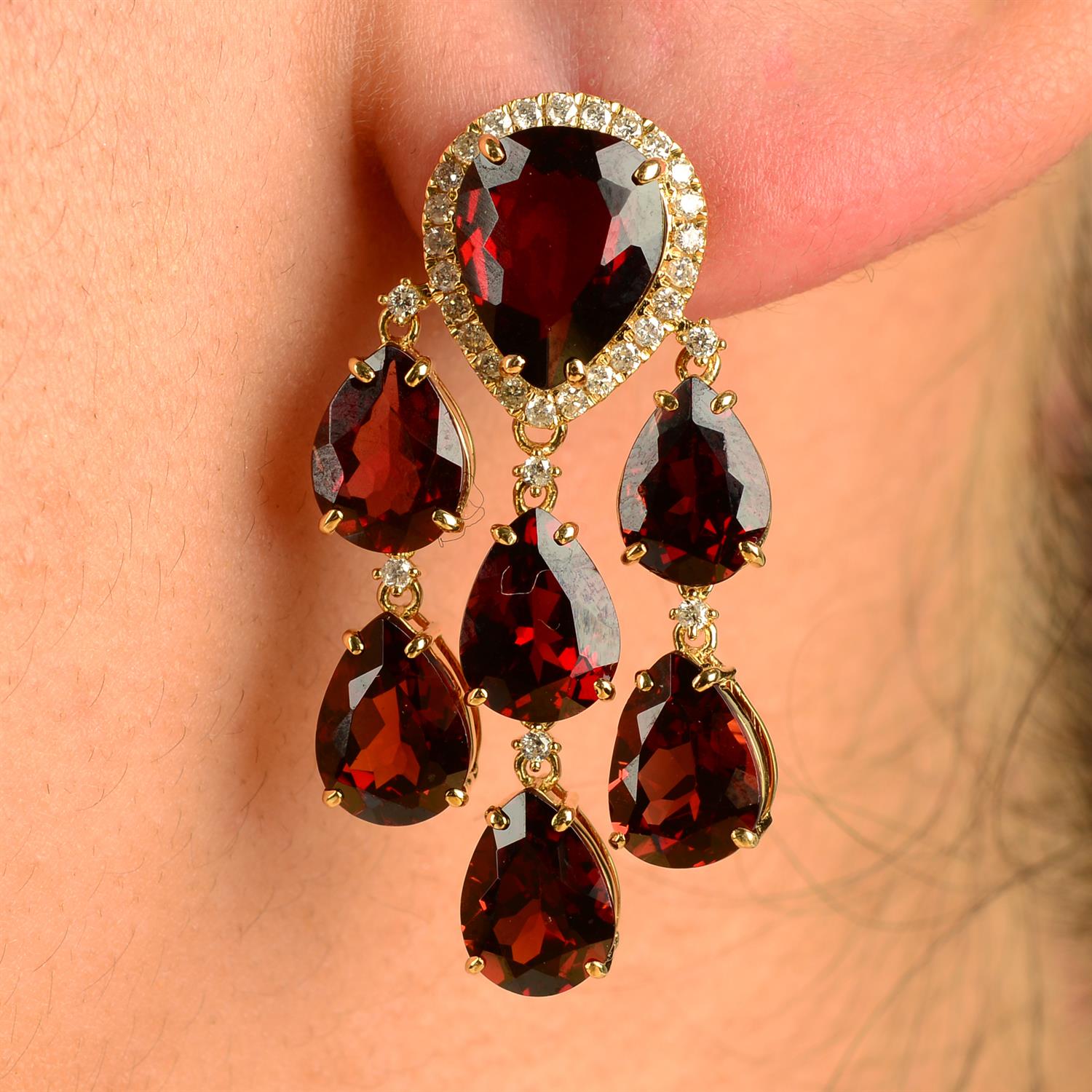 A pair of garnet and brilliant-cut diamond chandelier drop earrings.