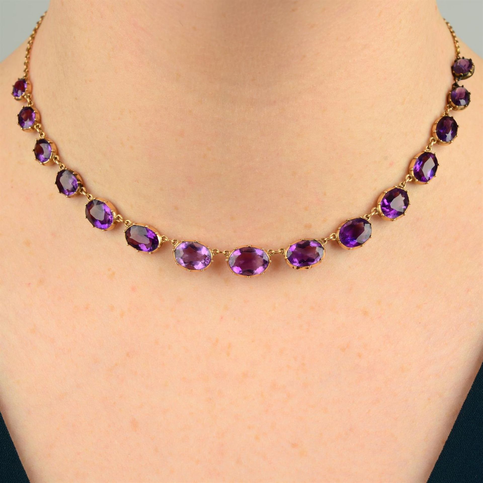 A 19th century gold graduated amethyst rivière necklace, with chain-link back-chain.