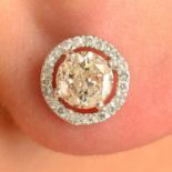A pair of brilliant-cut diamond stud earrings, with similarly-cut diamond halo.