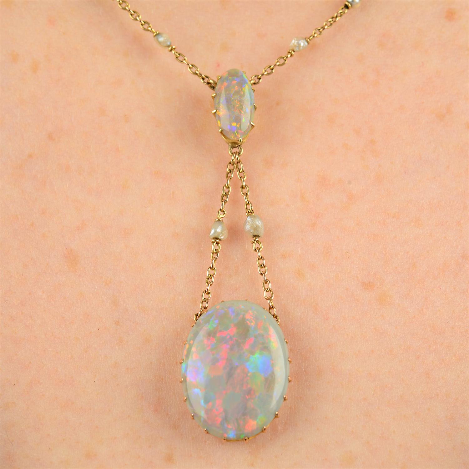 An early 20th century 14ct gold opal necklace, with seed pearl spacer trace-link chain.