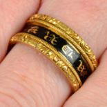 An early Victorian 22ct gold black enamel and gilt 'In Memory Of' band ring, with foliate embossed