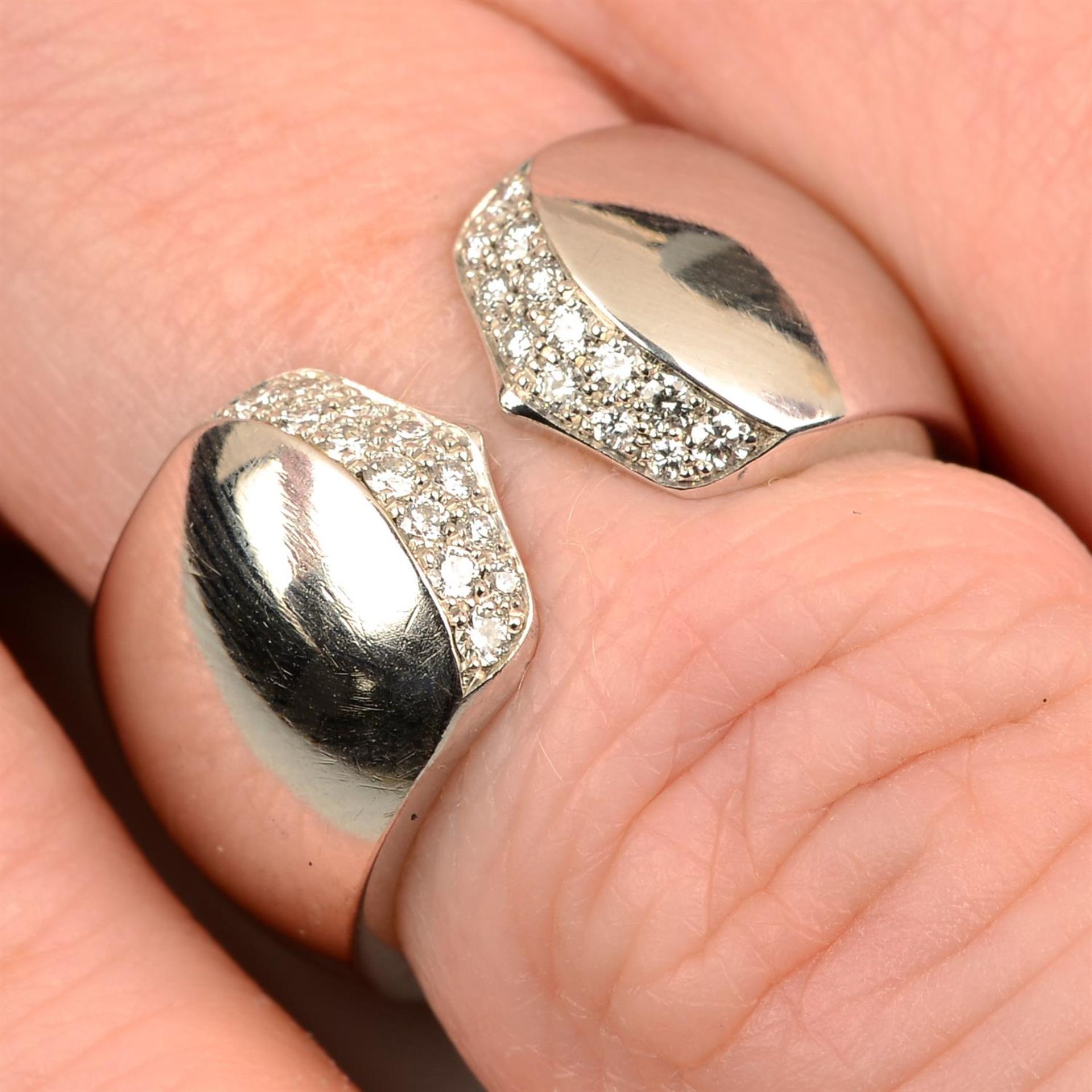 A pavé-set diamond open band ring, by Cartier.