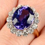 An 18ct gold tanzanite and brilliant-cut diamond cluster ring.