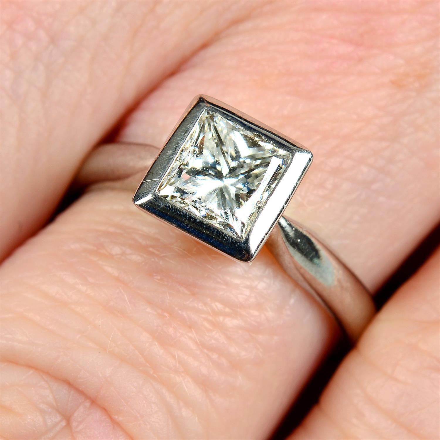 An 18ct gold square-shape diamond single-stone ring.