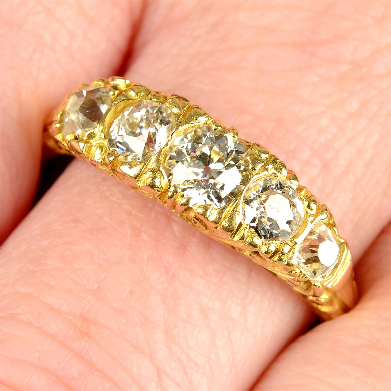 An early 20th century 18ct gold graduated old-cut diamond five-stone ring.