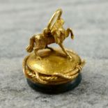 A Victorian gold bloodstone seal, with figural horse and encircling whip.