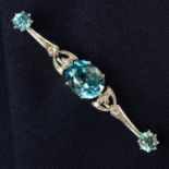 A mid 20th century palladium blue zircon and single and old-cut diamond bar brooch.