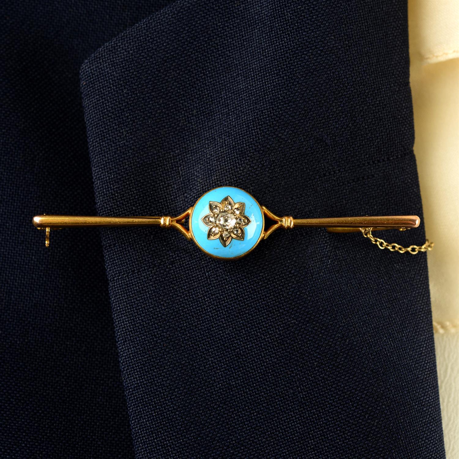 A late 19th century gold, floral vari-cut diamond and blue enamel bar brooch.