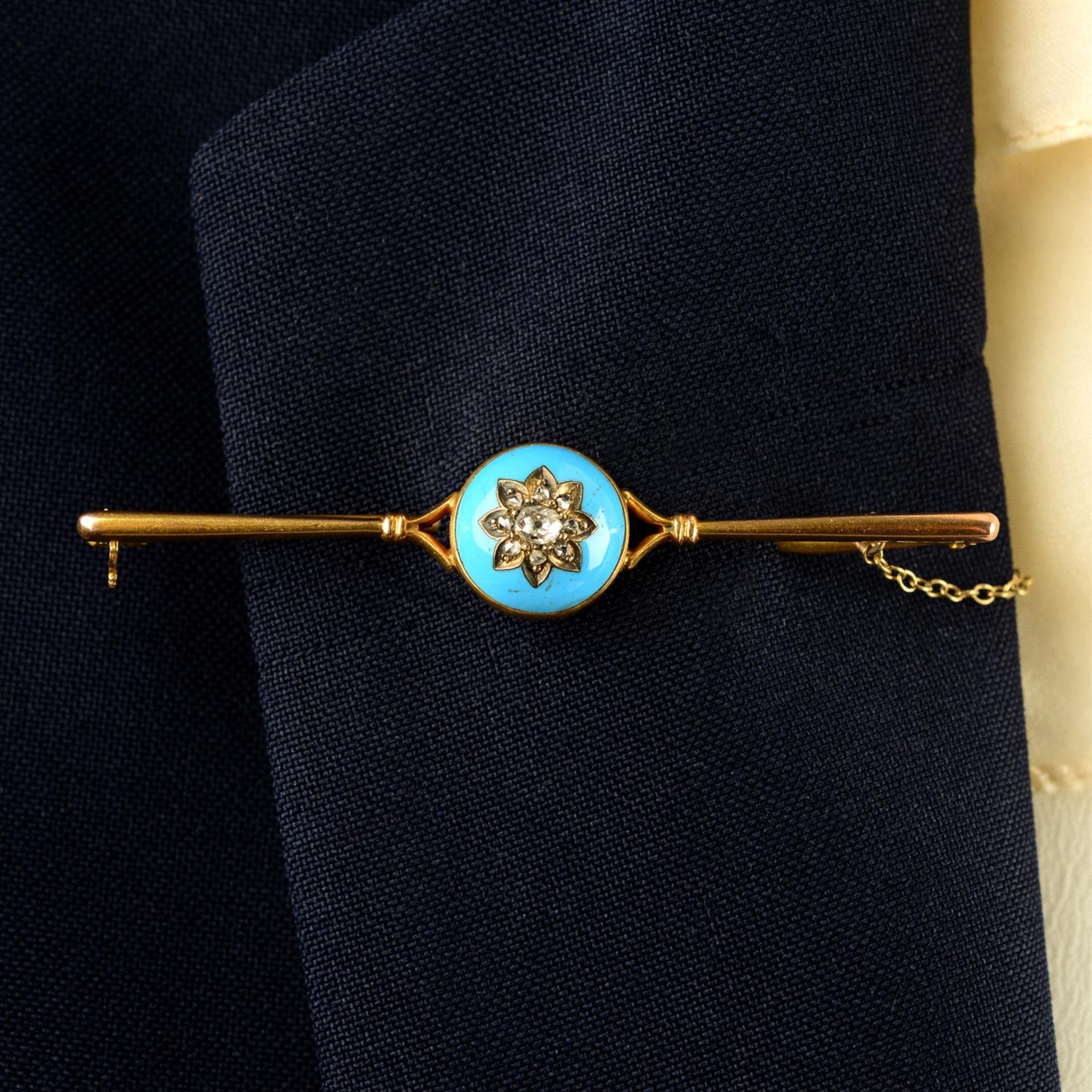 A late 19th century gold, floral vari-cut diamond and blue enamel bar brooch.