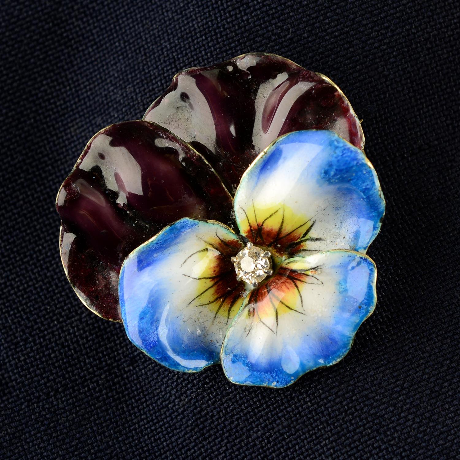 An early 20th century gold old-cut diamond and enamel pansy brooch.