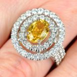 A yellow sapphire and brilliant-cut diamond cluster ring.