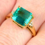A Colombian emerald and diamond accent ring.