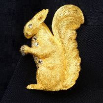 A mid 20th century 18ct gold old-cut diamond squirrel brooch, holding a rose-cut diamond nut,