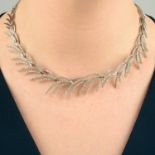 A brilliant-cut diamond foliate necklace.