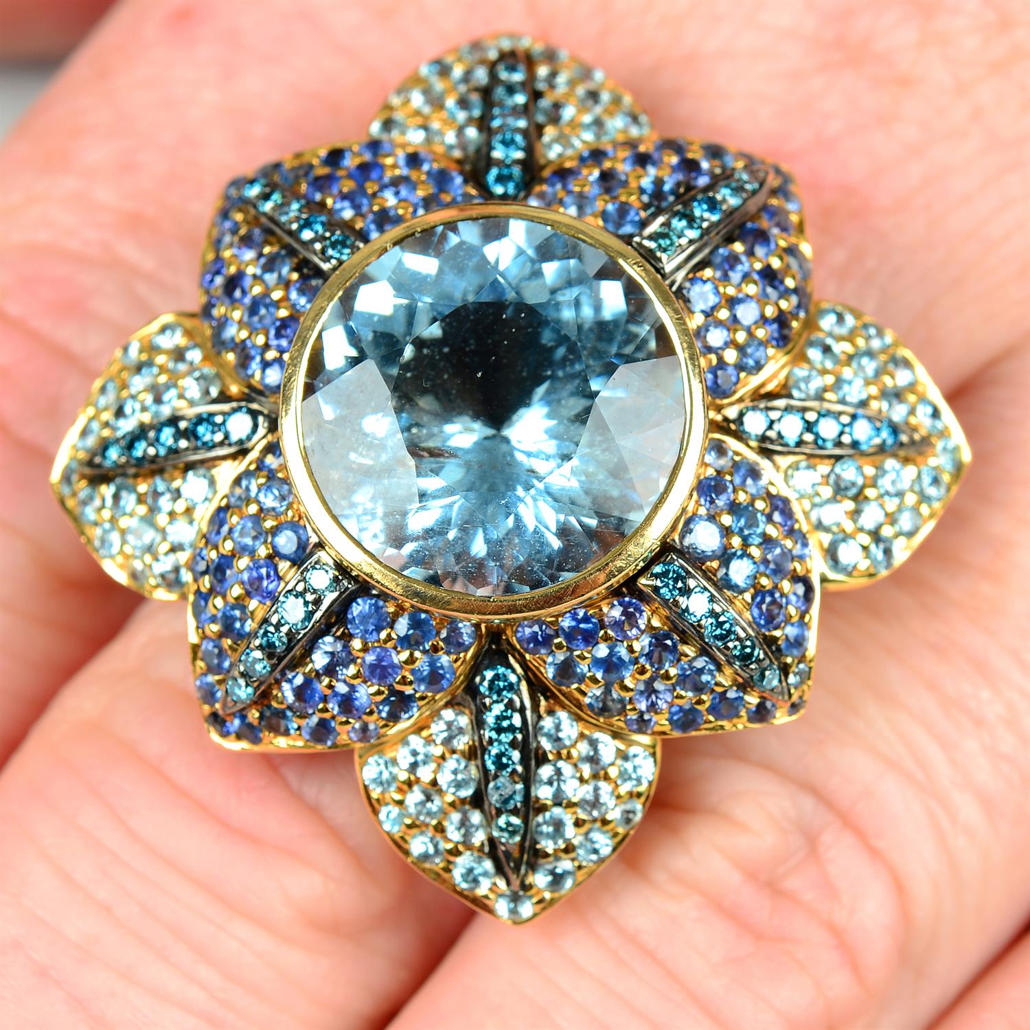An aquamarine, sapphire and colour-treated 'blue' diamond floral ring, by Zorab Creations.