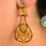 A pair of early 19th century gold floral earrings, each with right-facing profile portrait.