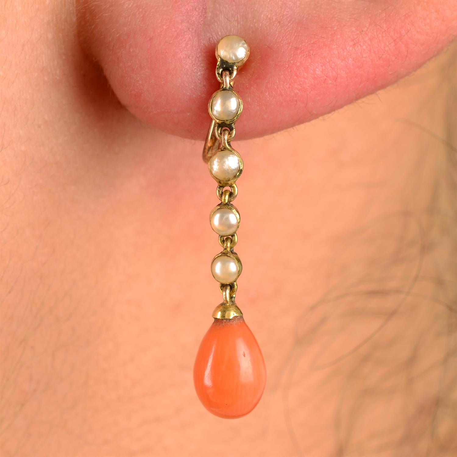 A pair of early 20th century 15ct gold coral and split pearl earrings.