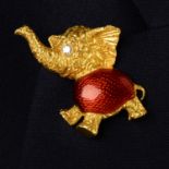 A mid 20th century 18ct gold diamond and red enamel elephant brooch.