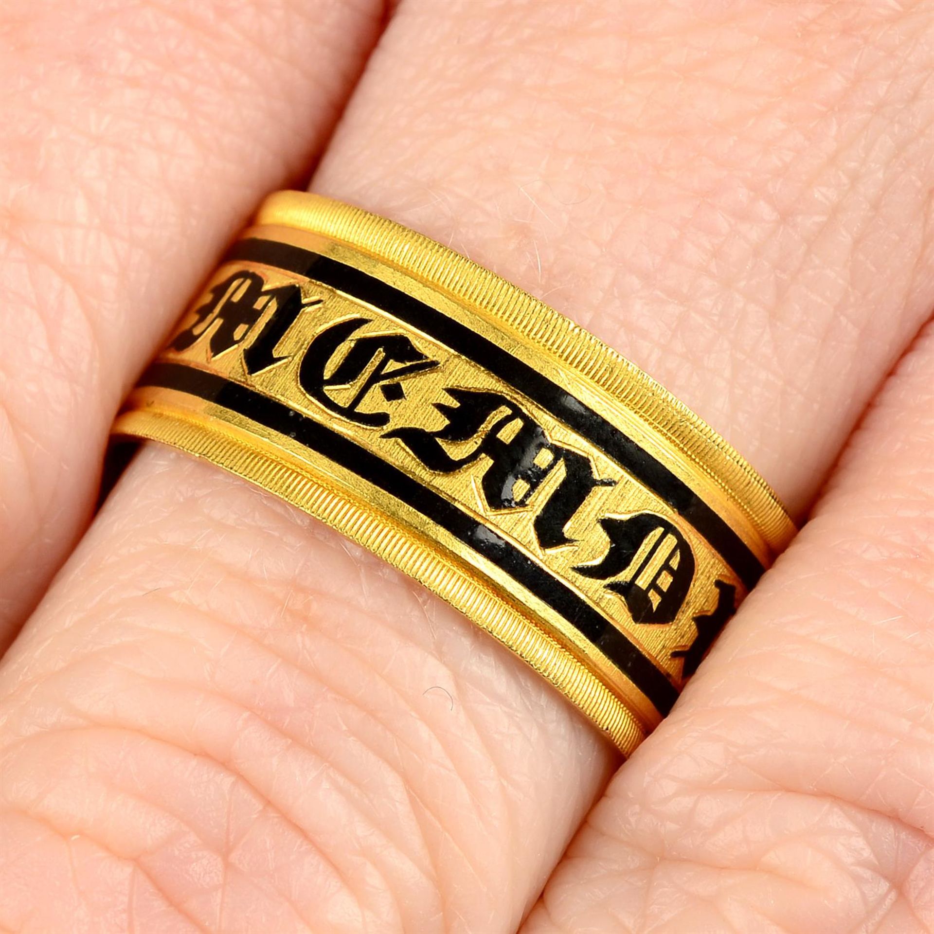 A late Georgian gold black enamel 'In Memory Of' memorial band ring.