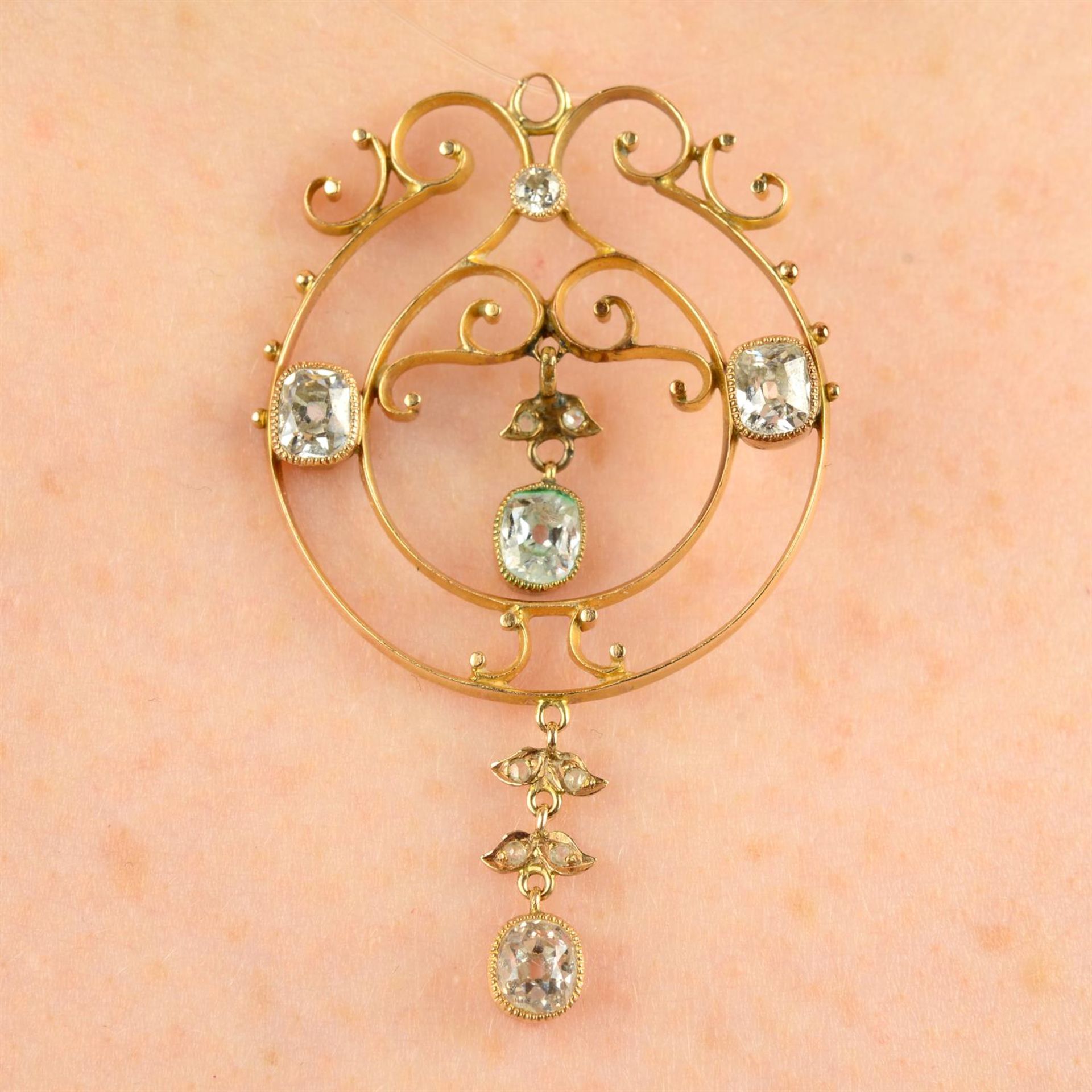 An early 20th century gold rose and old-cut diamond openwork pendant.