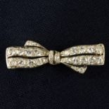 An early 20th century platinum and gold circular-cut diamond bow brooch.