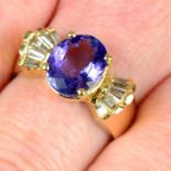 A tanzanite dress ring, with tapered baguette-cut diamond sides.