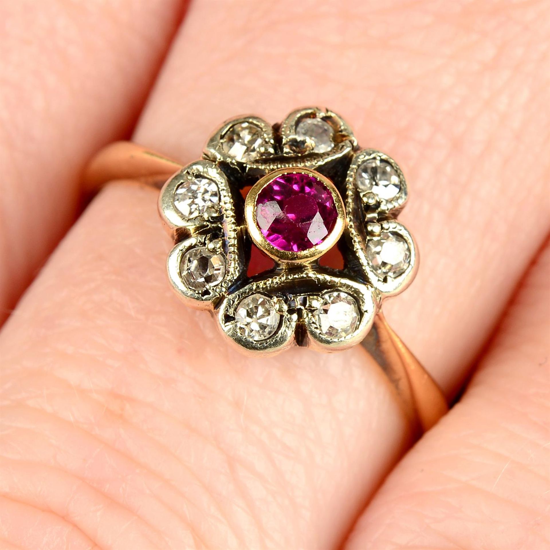 A mid 20th century 18ct gold ruby and single-cut diamond floral cluster ring.
