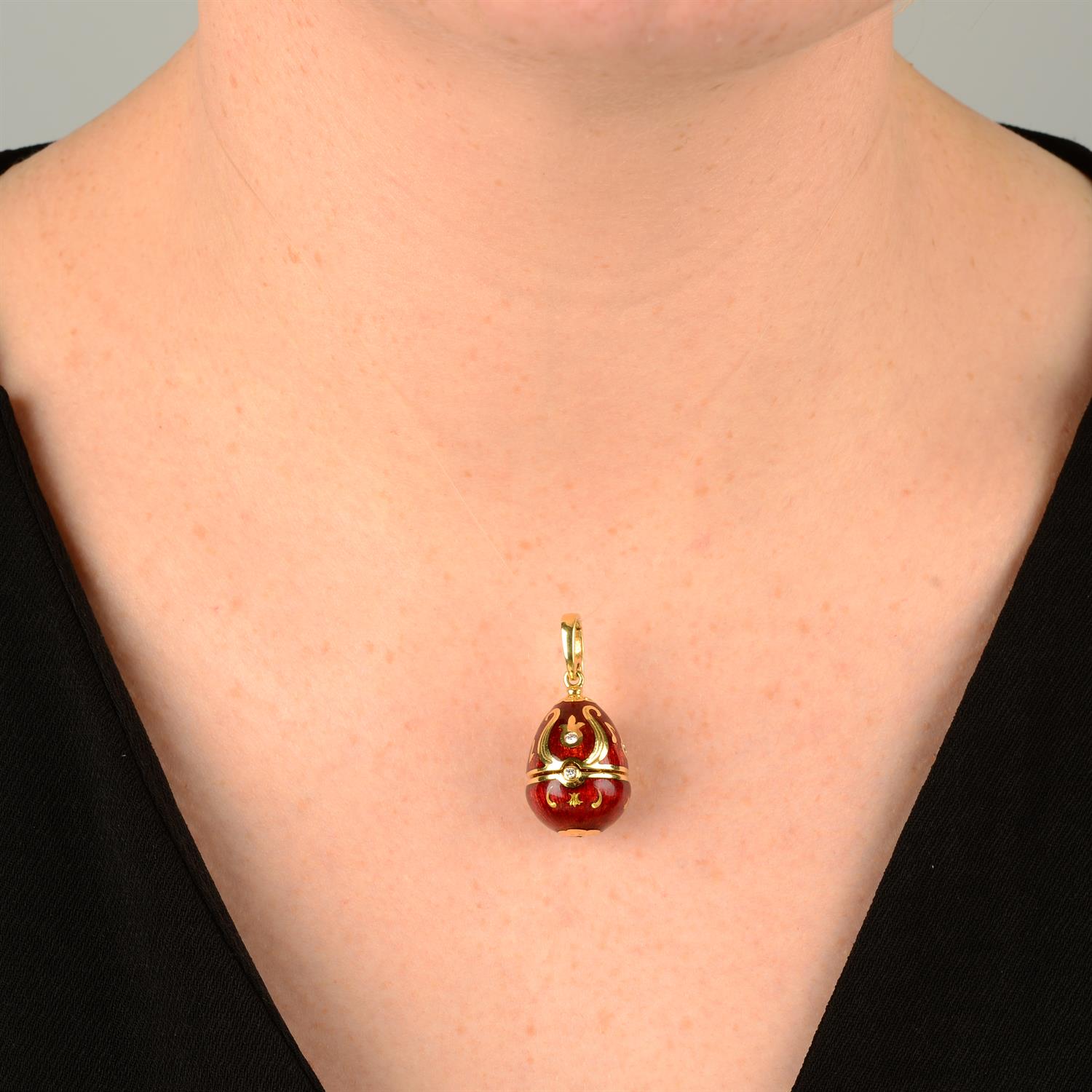 A limited edition 18ct gold diamond and red enamel hinged egg pendant, containing a treble clef, - Image 5 of 5
