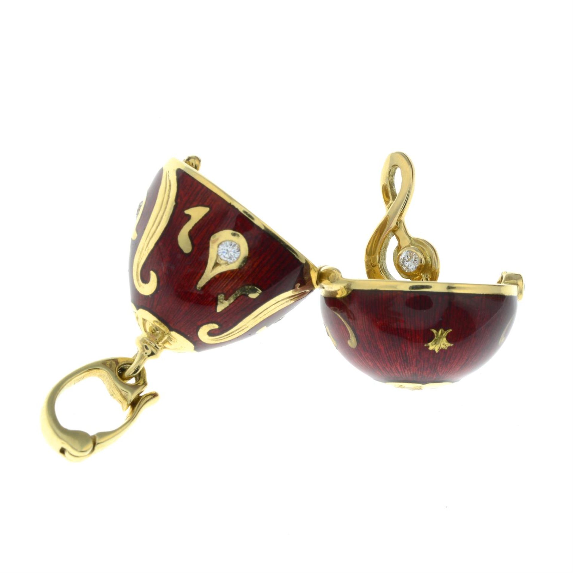 A limited edition 18ct gold diamond and red enamel hinged egg pendant, containing a treble clef, - Image 4 of 5