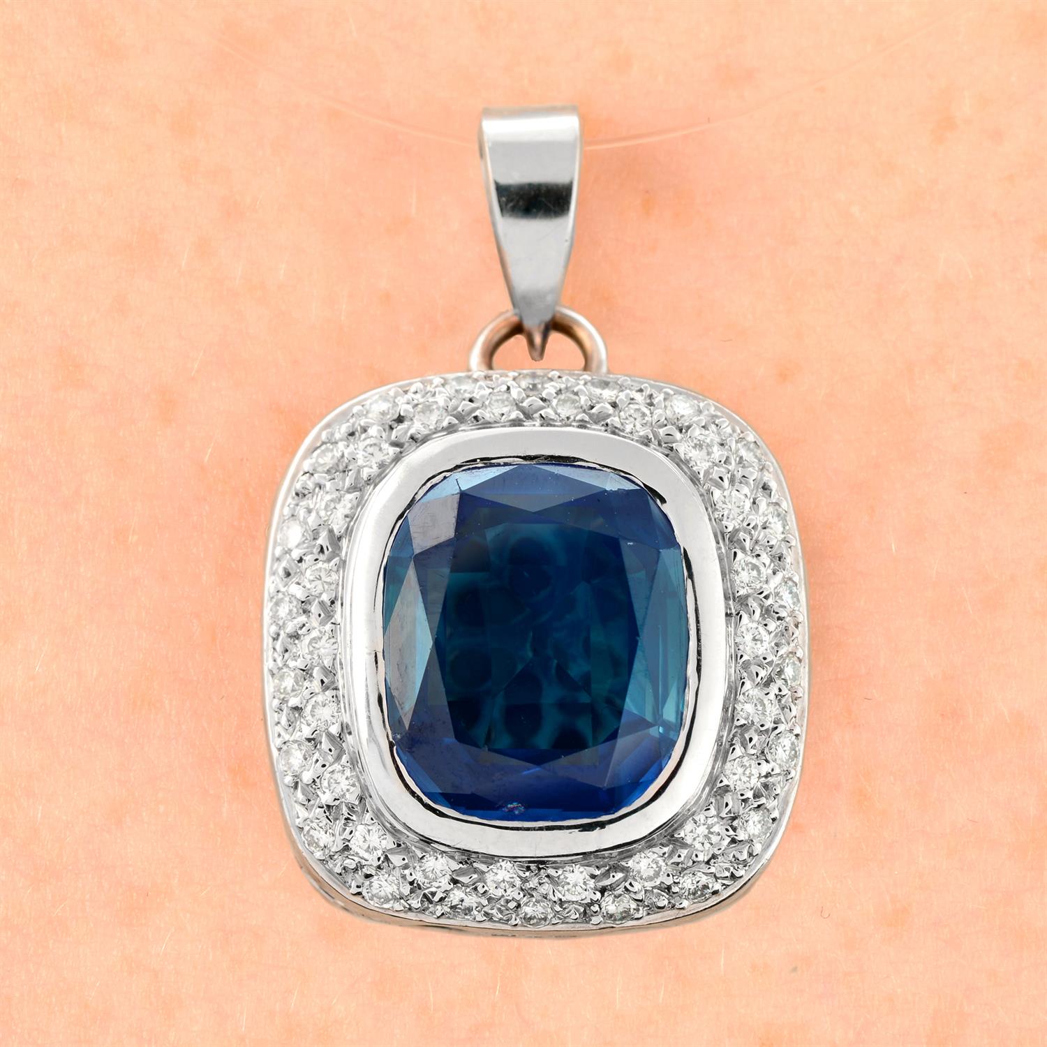 A Sri Lankan sapphire and pavé-set diamond pendant.