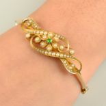 An early 20th century 15ct gold demantoid garnet and split pearl floral hinged bangle.