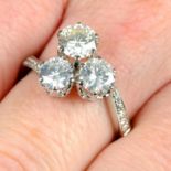 A graduated brilliant-cut diamond three-stone crossover ring.