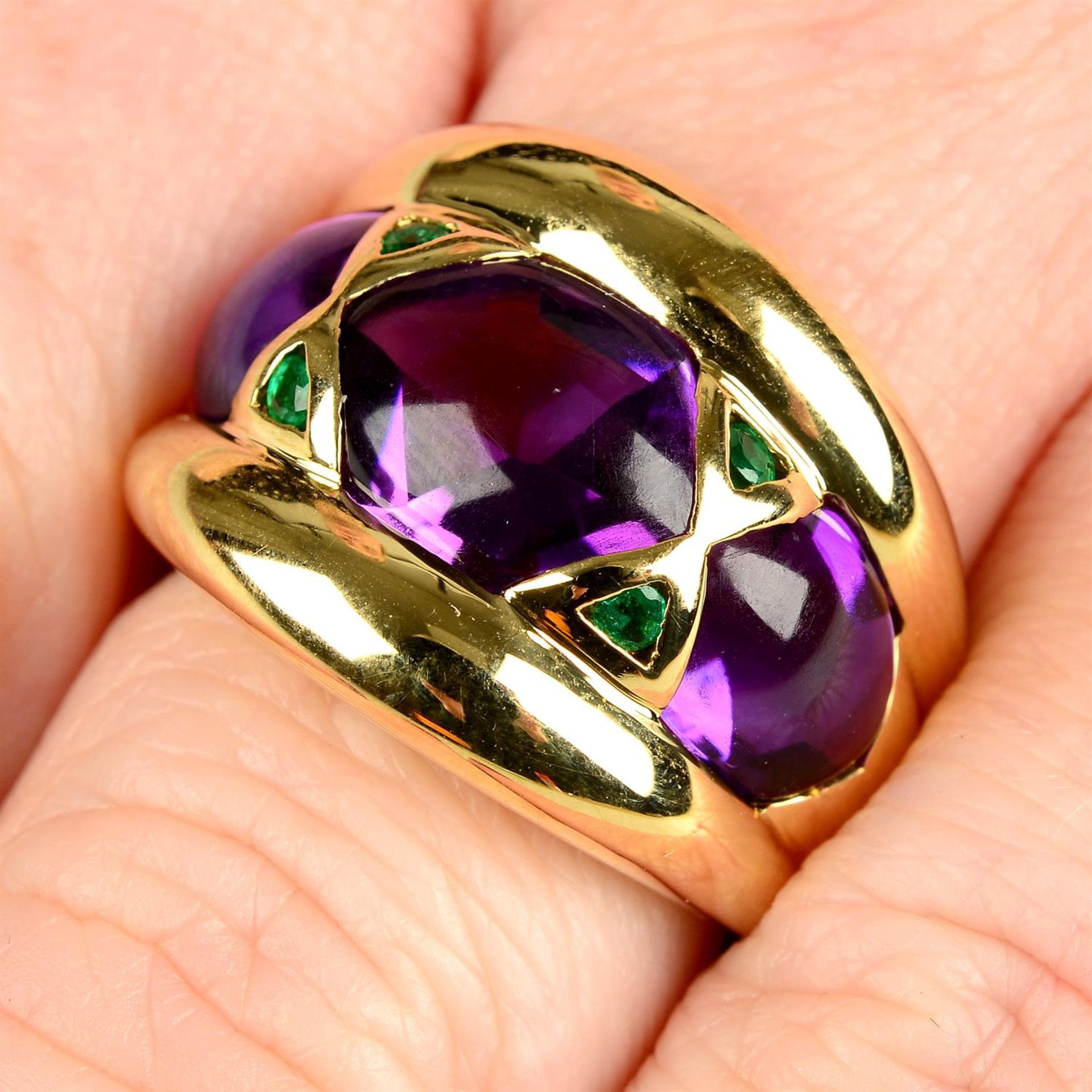 A gold cabochon amethyst and emerald dress ring.