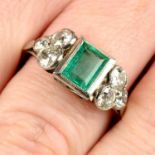 An emerald dress ring, with graduated old-cut diamond trefoil sides.