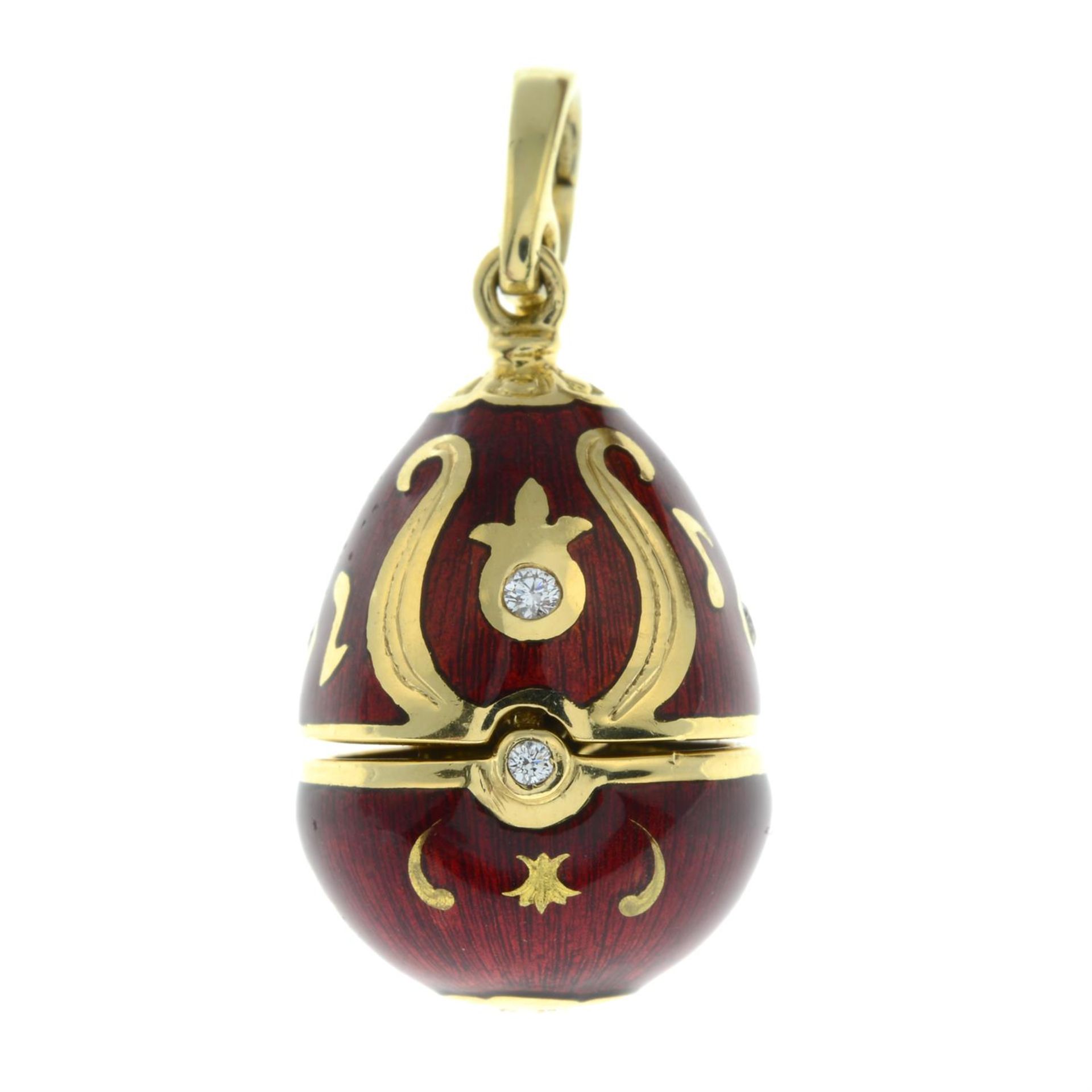 A limited edition 18ct gold diamond and red enamel hinged egg pendant, containing a treble clef, - Image 2 of 5