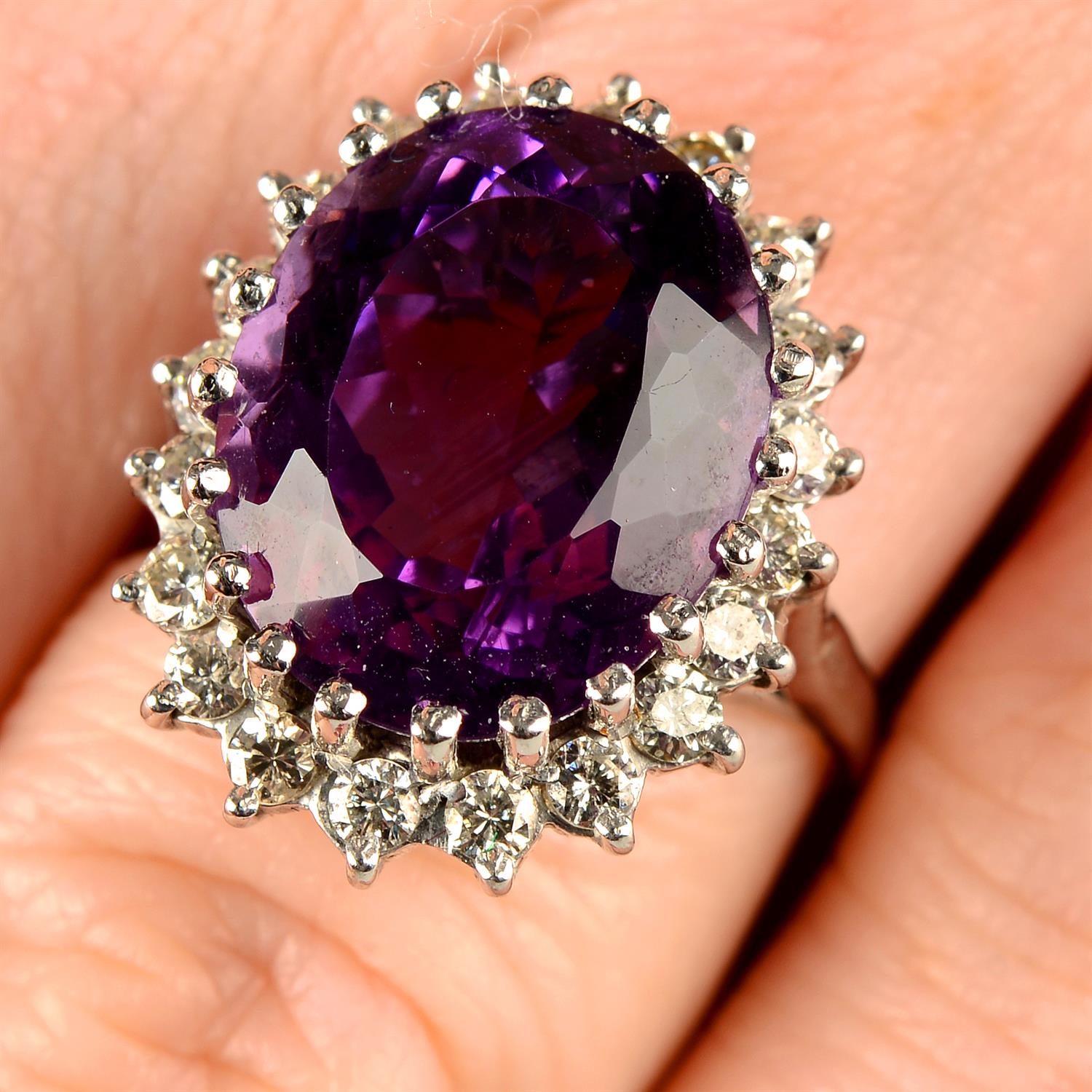 An 18ct gold amethyst and brilliant-cut diamond cluster ring.
