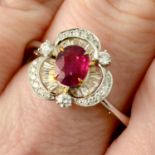 A ruby, brilliant and tapered baguette-cut diamond floral cluster ring.