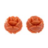 A pair of carved coral floral stud earrings.