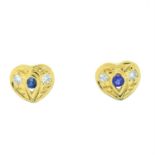 A pair of sapphire and diamond heart stud earrings.