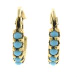 A pair of blue gem earrings.