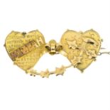An Edwardian 15ct gold Mizpah double heart brooch.